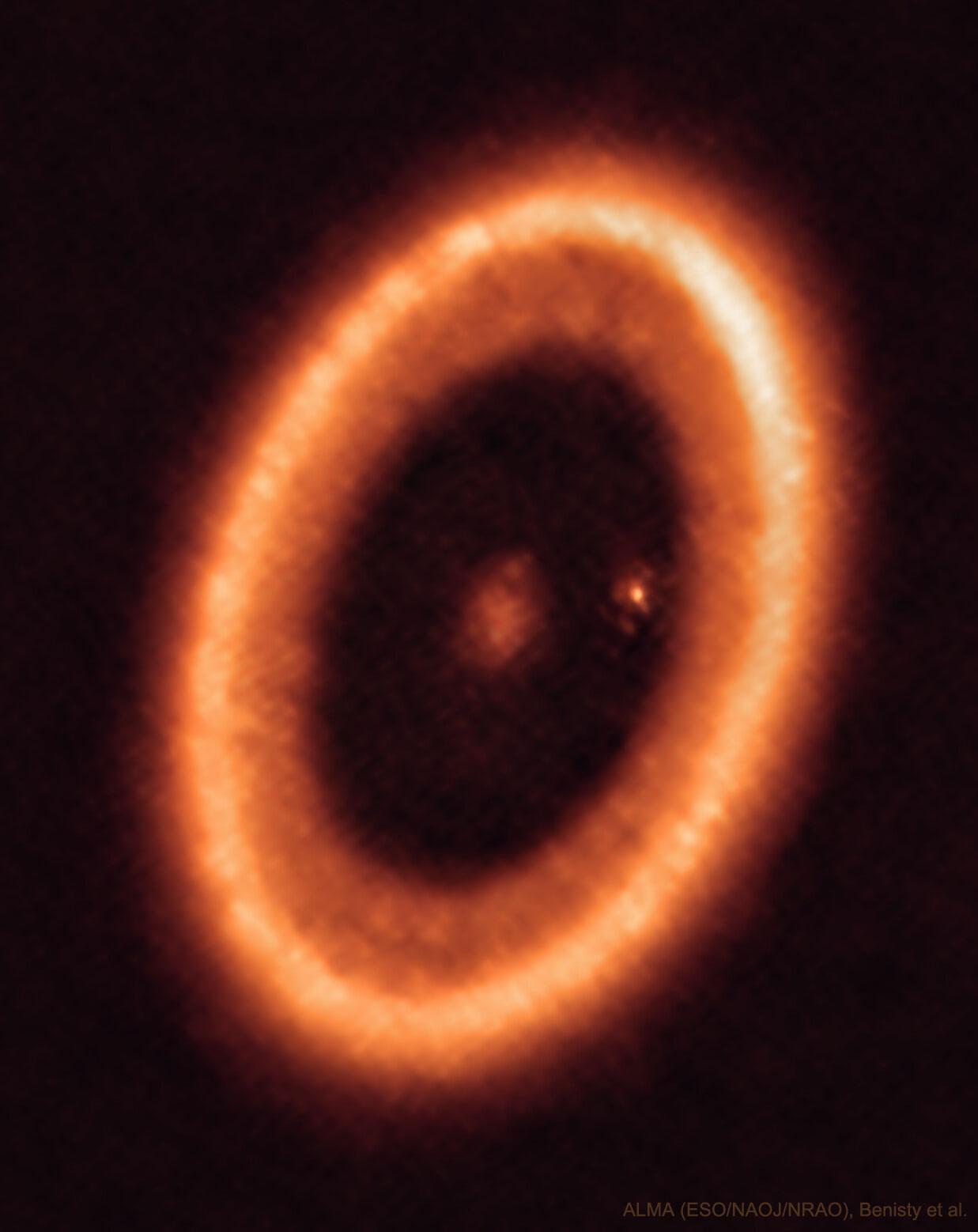 حلقةٌ إهليلجيّةٌ برتقاليّةٌ هي قرصٌ من الغاز والغبار حول النجم "پي‌دي‌إس 70". في مركز القرص توجد بقعة زغبة وقرب الحافّة اليُمنى الداخليّة للقرص توجد بقعة زَغِبة أُخرى.