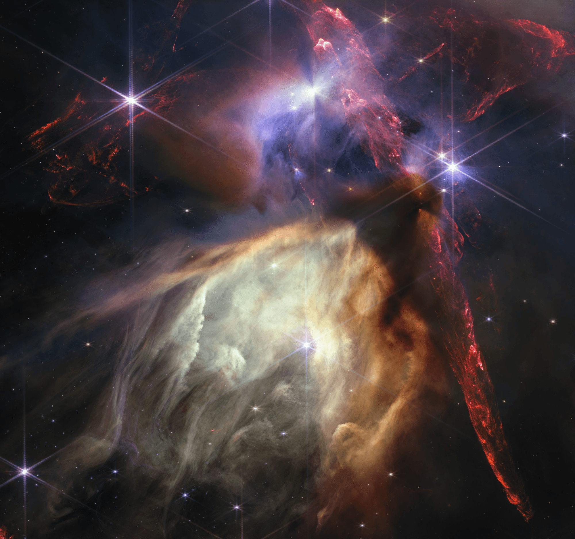 تكوين سديمي يظهر كامتدادات حمراء وتحتها تجويف مصفرّ في حين تظهر نجوم ذات أشواك حيود سداسيّة كبيرة
